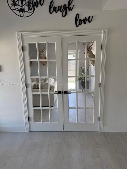 The recreational room entrance to the left of the house entrance.