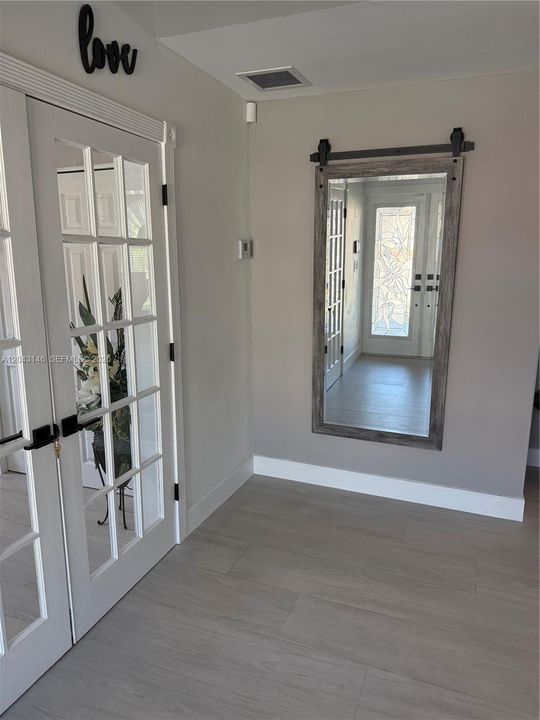 The entrance foyer with recreational room to the left.