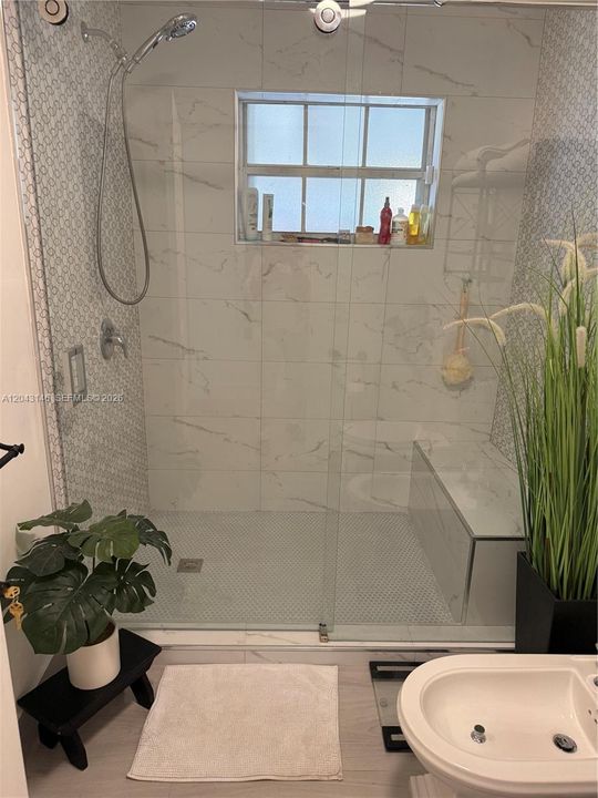 Master bathroom has a Kohler bidet, toilet, and seating in shower.