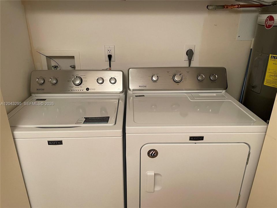 Full-sized washer and dryer in unit.