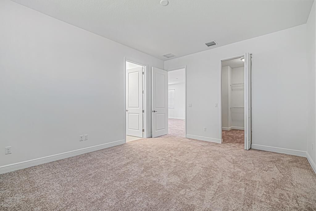 Walk in closet in primary bedroom
