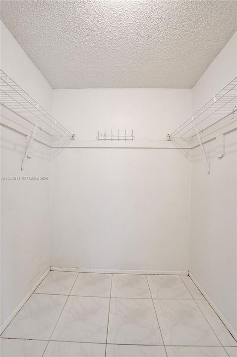 WALK-IN CLOSET IN PRIMARY BEDROOM
