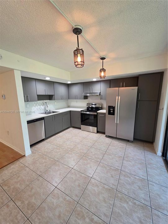 BEAUTIFULLY REMODELED KITCHEN WITH BRAND NEW TOP OF THE LINE APPLIANCES