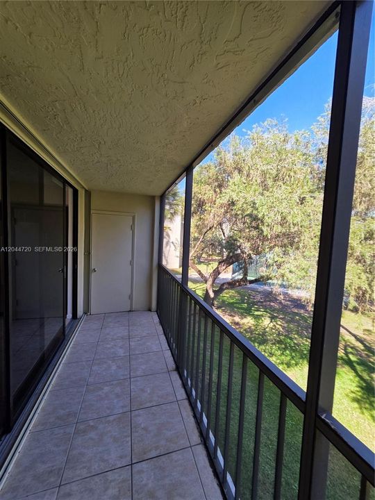 SCREENED BALCONY WITH STORAGE ROOM