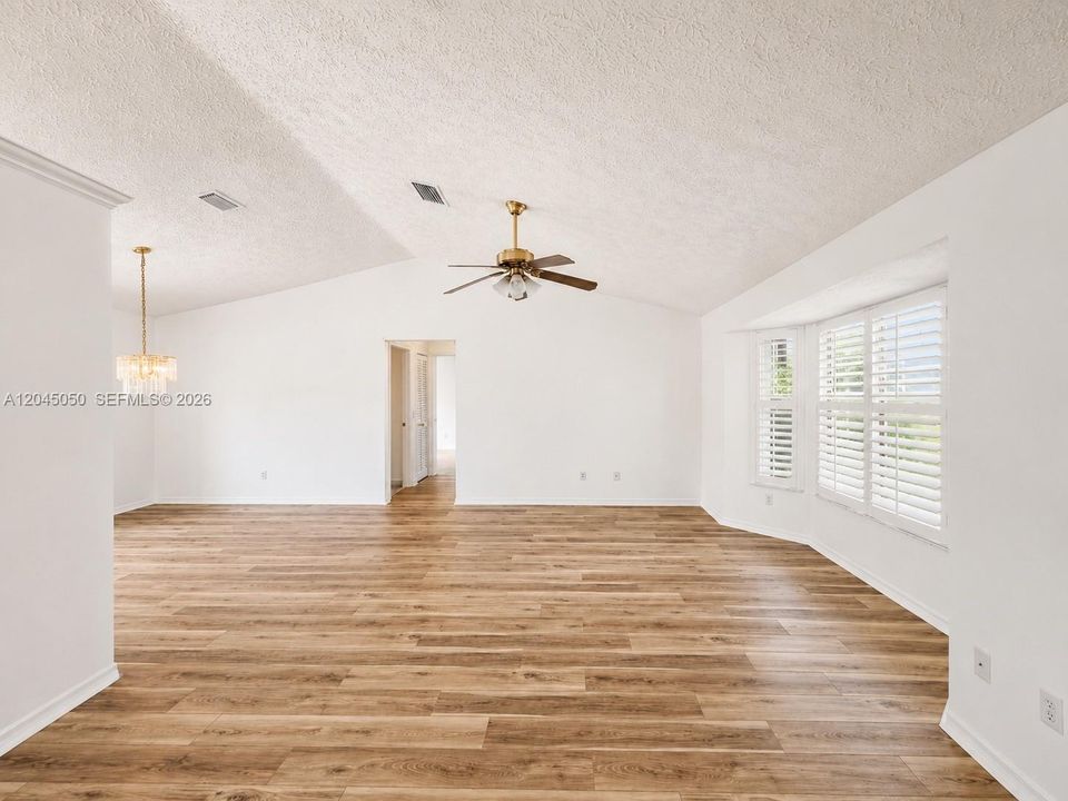 living area view rom the entrance, Bay window and plantation shutters with high ceilings.