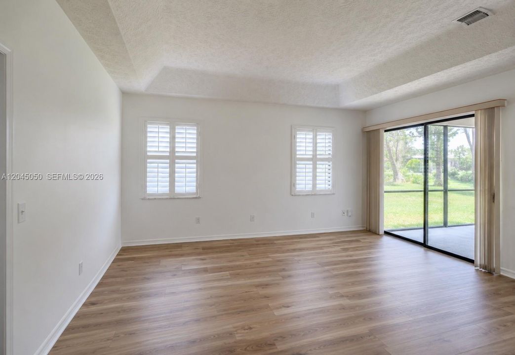 Master bedroom, plantation shutters, private screened patio