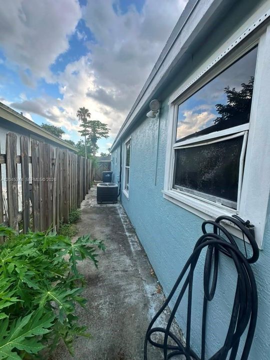 Side exterior area with covered access and additional outdoor space