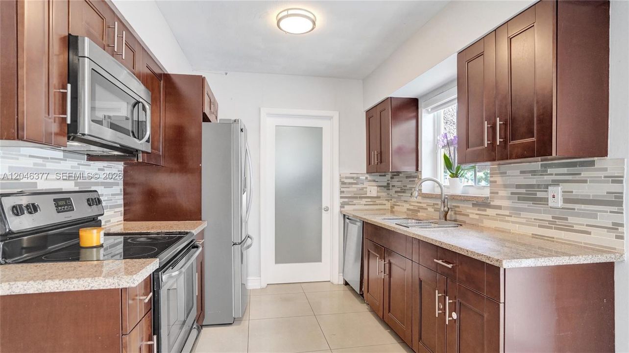 Frosted glass door leads to laundry room