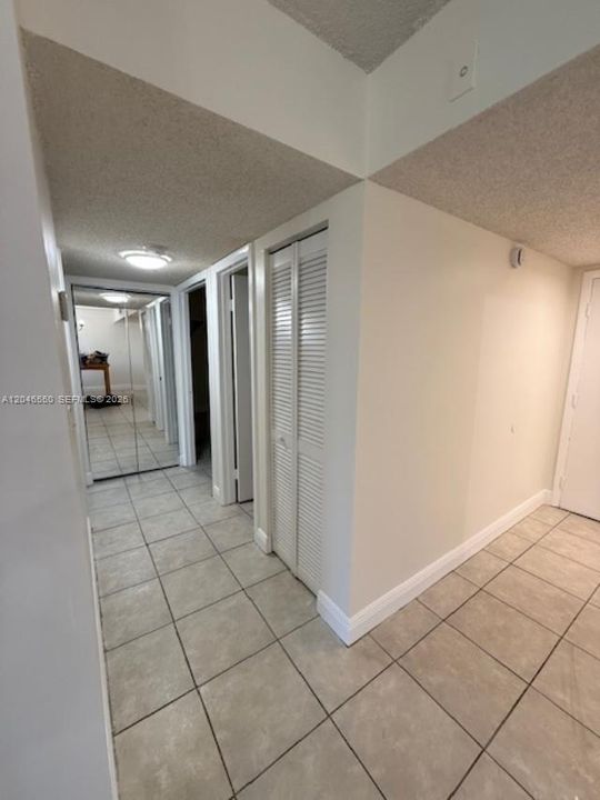 hallway leading to bedrooms and baths