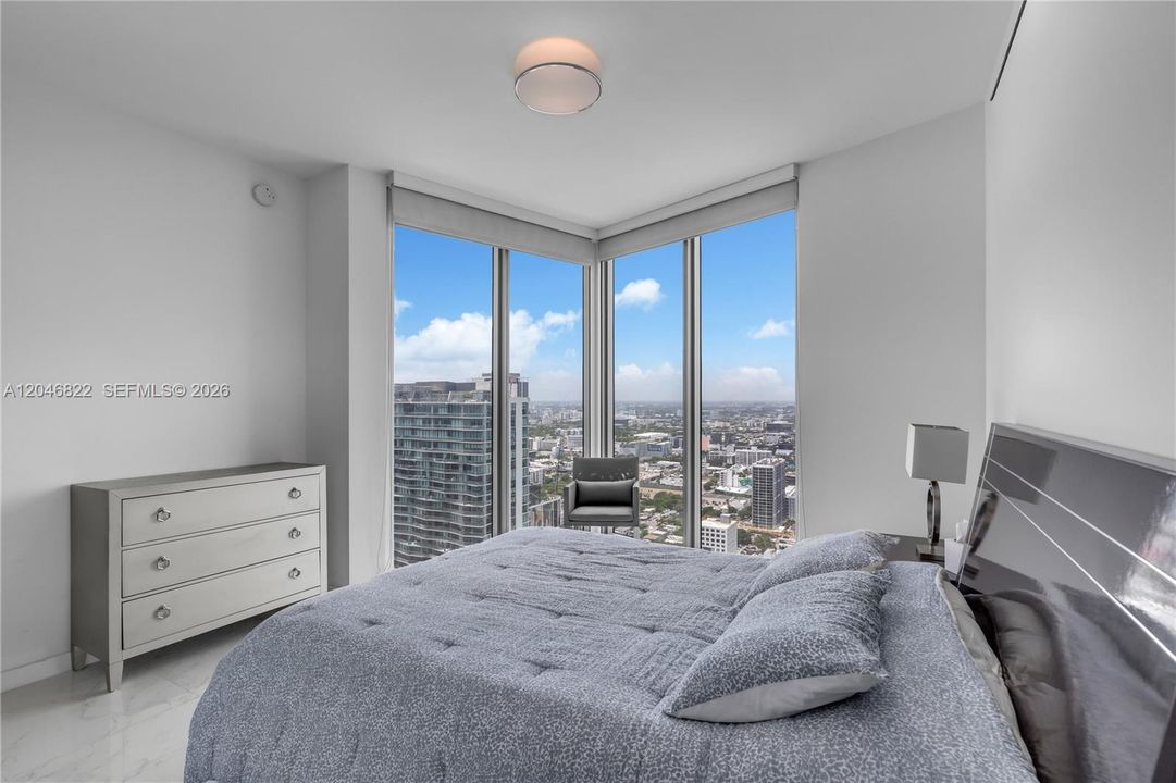 Guest bedroom with corner windows and sweeping city views