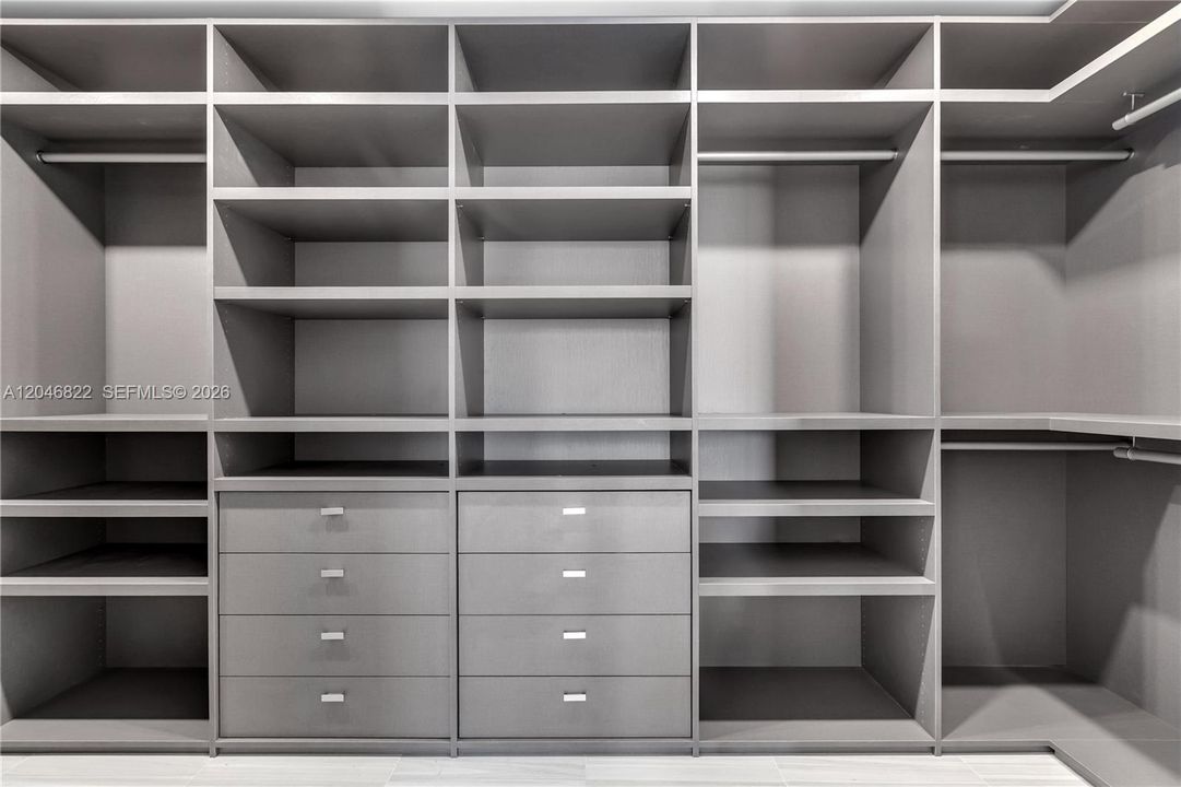 Oversized walk-in closet with fully built-out cabinetry