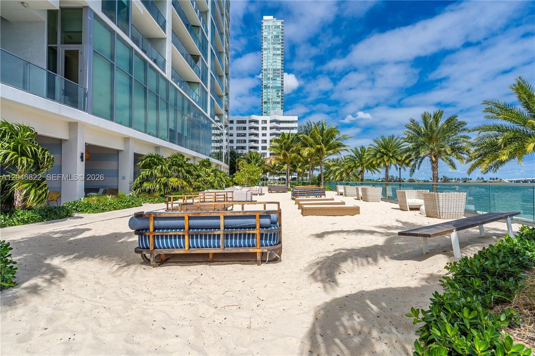 Private man-made beach and daybeds on Biscayne Bay