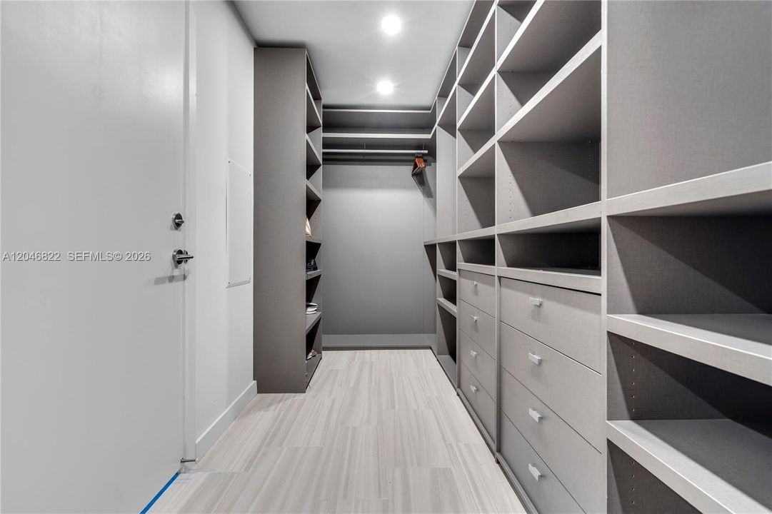Custom walk-in closet with built-in shelving and drawers