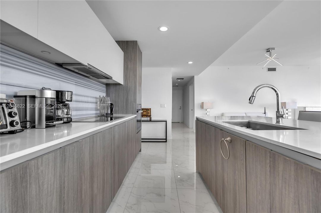 Waterfall quartz island with integrated sink and built-in Miele oven