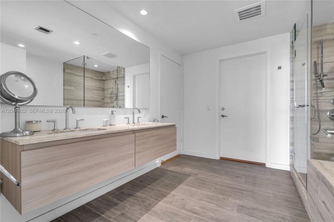Spa bath with dual-sink floating vanity and wood-look tile