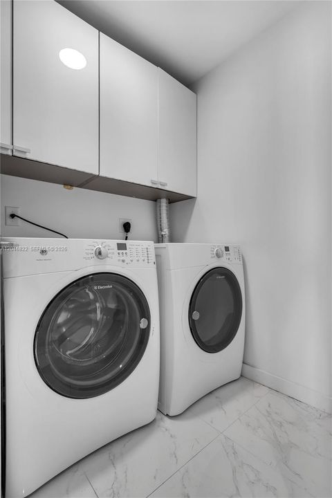 In-unit laundry room with full-size washer and dryer