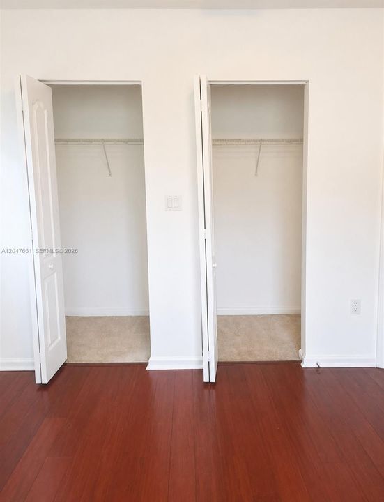 Dual primary bedroom closets offering ample storage ample storage.