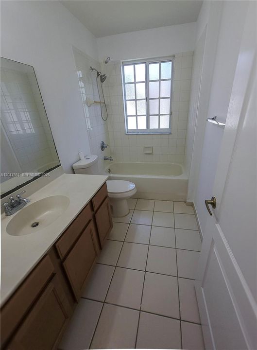 upstairs hallway bathroom featuring a spacious vanity, tub/shower combination, and convenient access from the secondary bedrooms.
