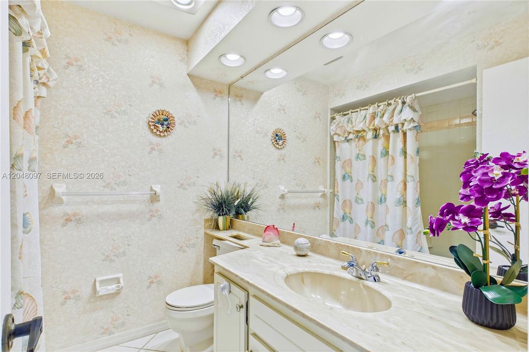 Guest bathroom with a spacious vanity and full tub/shower combo. Neutral finishes keep the space bright and inviting. Conveniently located for family or visiting guests