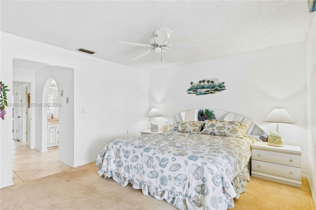 Spacious primary bedroom with room to unwind and a peaceful, airy feel.