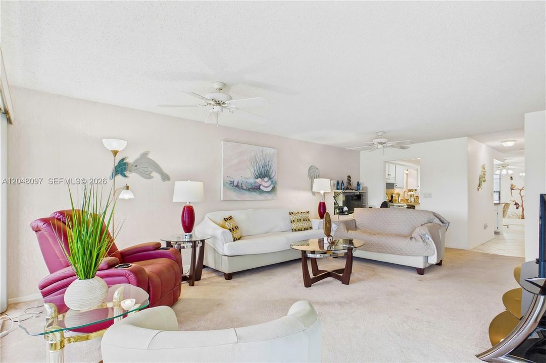 Inside, the condo features an OPEN AND AIRY FLOOR PLAN with a tasteful blend of tile and carpet flooring