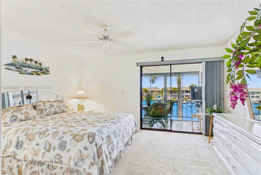 From the primary suite, you have direct access to the SCREENED BALCONY overlooking the wide canal!