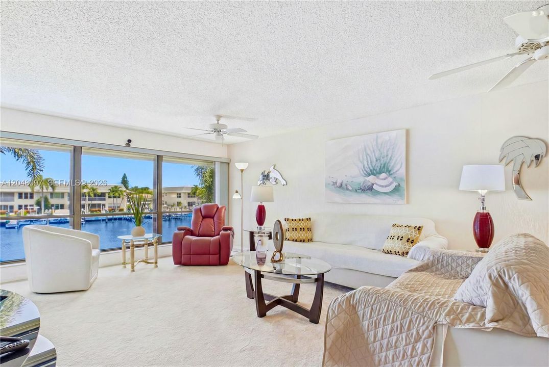 The generous living room is filled with natural light and CAPTIVATING WATER VIEWS, making it ideal for entertaining or peaceful evenings at home!