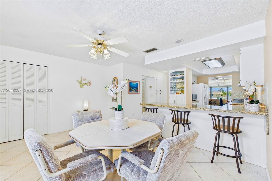 Bright dining area with an open flow to the kitchen and breakfast bar seating