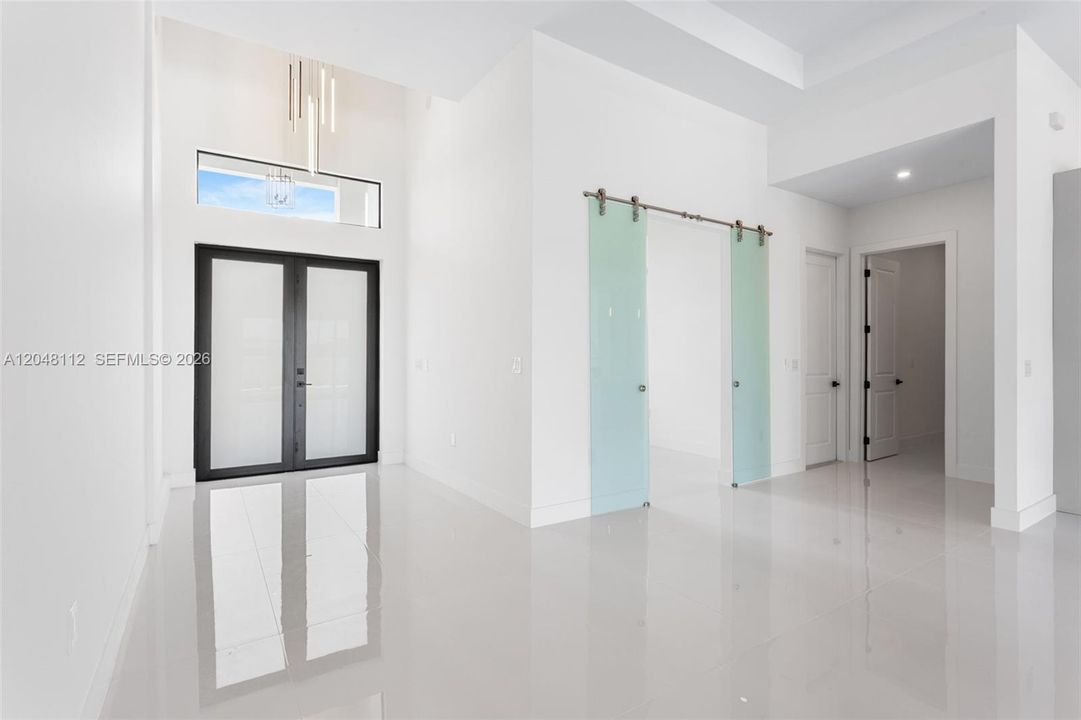 Enter through the COVERED FRONT PORCH and GRAND DOUBLE DOORS into a SOARING 16-FT FOYER, where a NEUTRAL PALETTE OF WHITE, LIGHT GRAY, and CASHMERE WELCOMES YOU HOME!