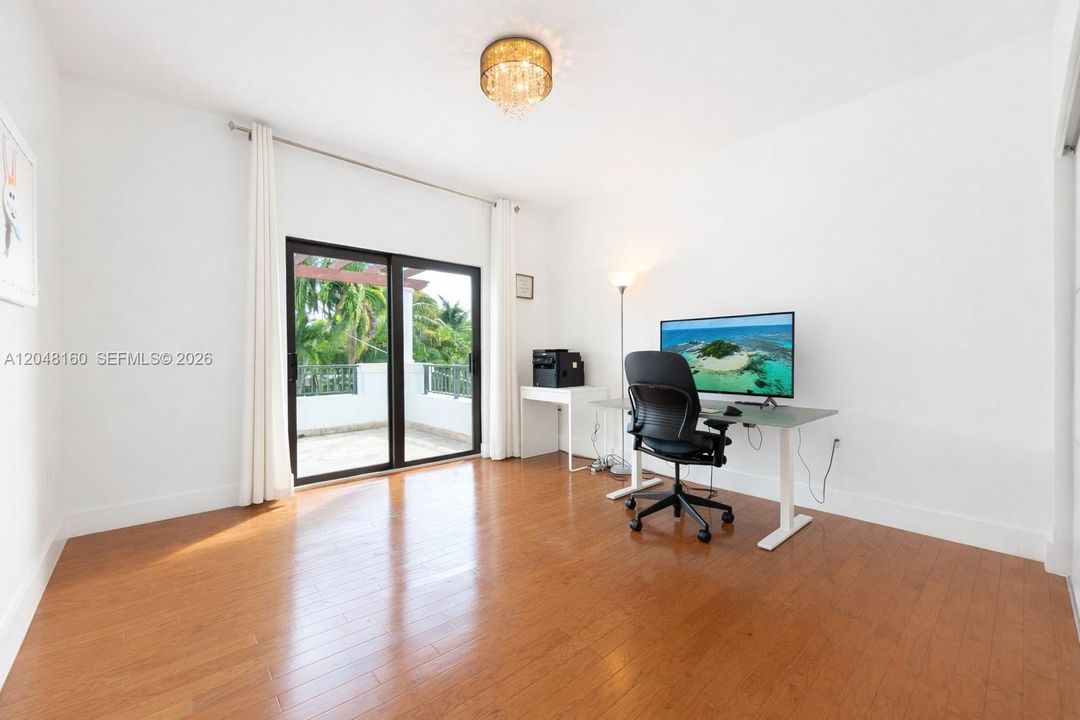 second floor bedroom with ensuite bathroom faces back yard and connects to large second floor terrace via floor-to-ceiling glass door. Large built in closets.