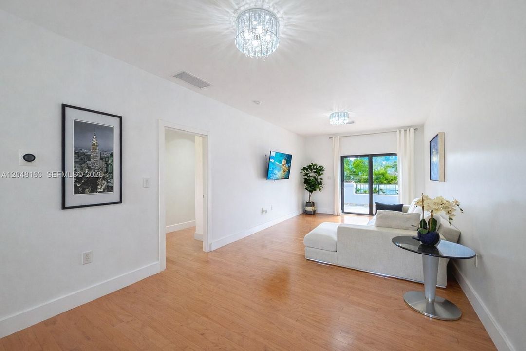 oversized landing and recreation area leading to second floor terrace overlooking back yard.
