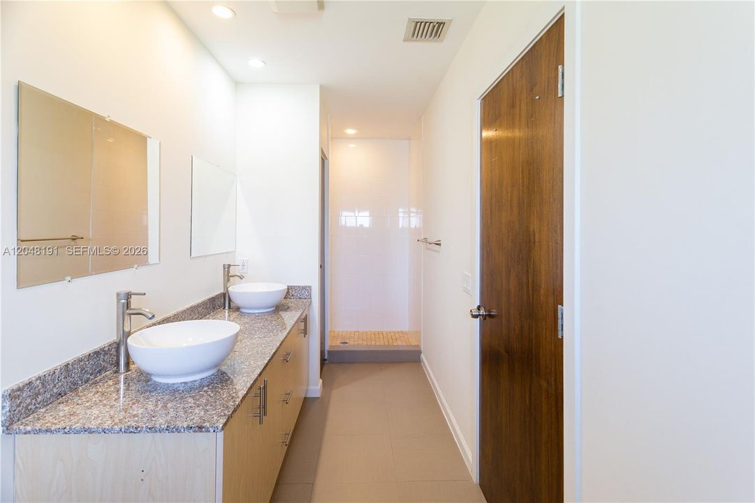 Master bathroom with jacuzzi, shower and dual sinks