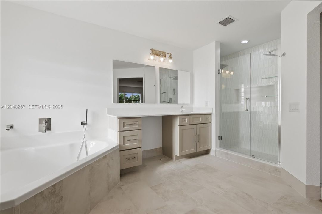 Ample garden tub and a shower w/double shower heads