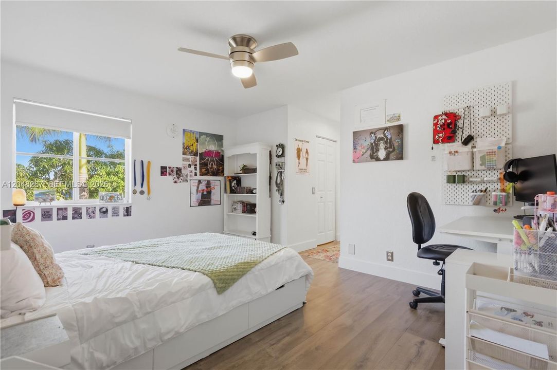 Bedroom 6 which is a mini suite on its own. Queen size bed pictured. En-suite bathroom at the end of the hallway.