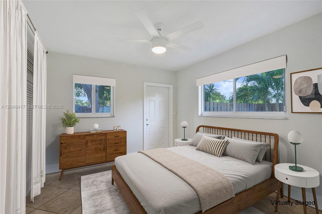 Primary Bedroom. -Door leads to private enclose backyard. -Virtually Staged