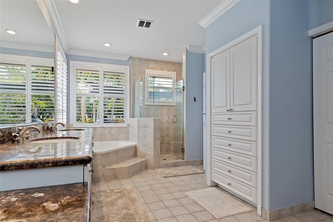 Spa-inspired bathroom with soaking tub, Separate walk-in shower, Dual vanities, Two walk-in closets