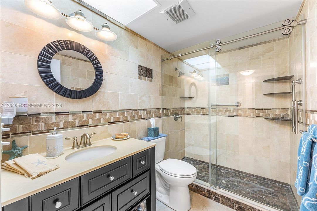 Updated guest bath with glass enclosed shower