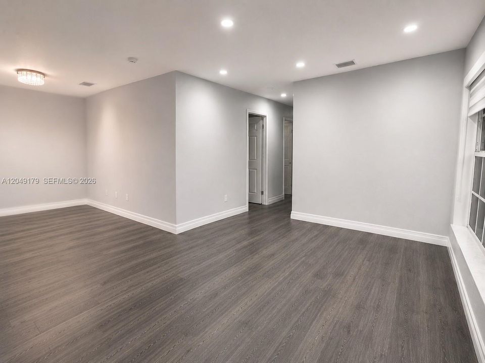 The spacious Florida room provides a versatile extension of the living space—ideal for relaxing, entertaining, or creating the ultimate media room.