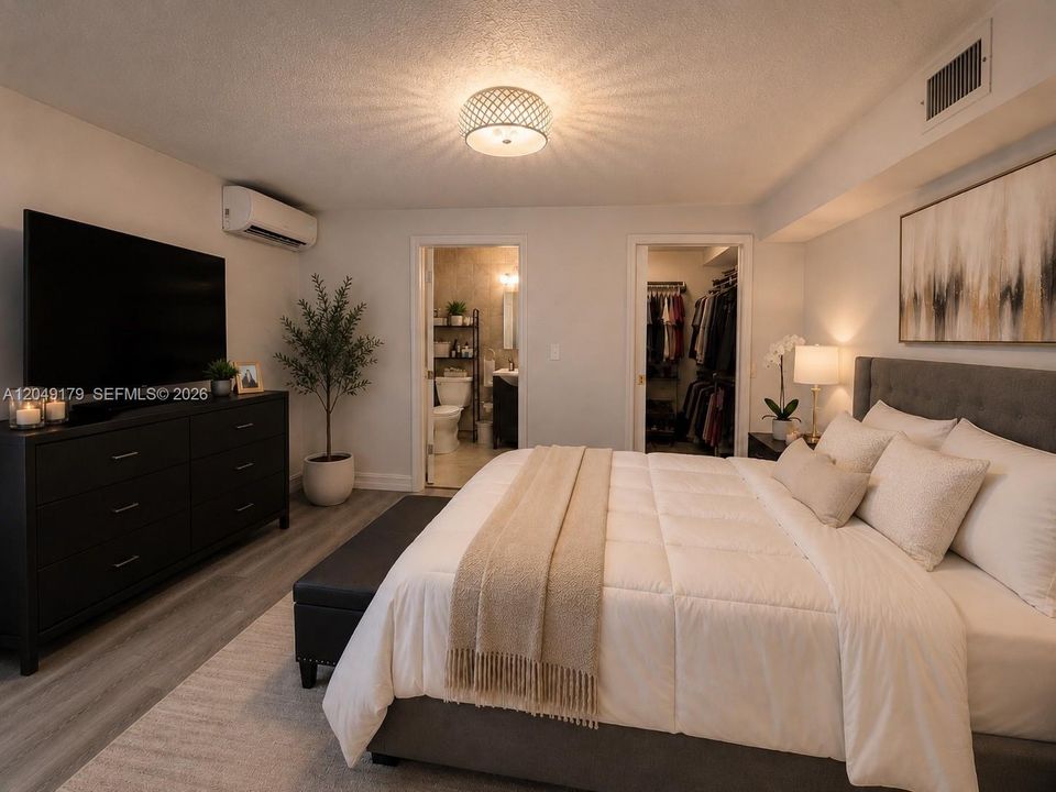 Private primary en-suite bath featuring a walk-in shower, timeless tile finishes, and a functional vanity with additional storage.