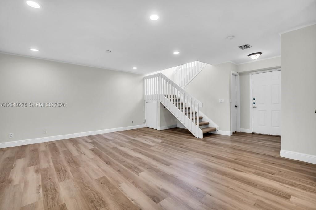 Large living area with stairway to 2nd story