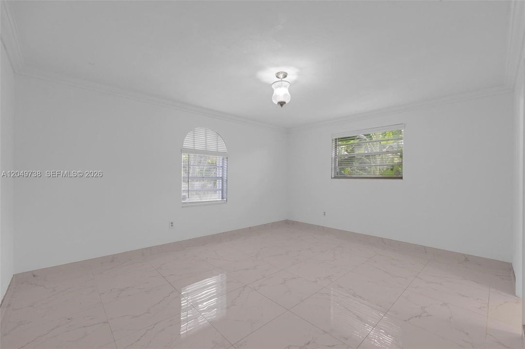 Large corner master bedroom with front and side yard view