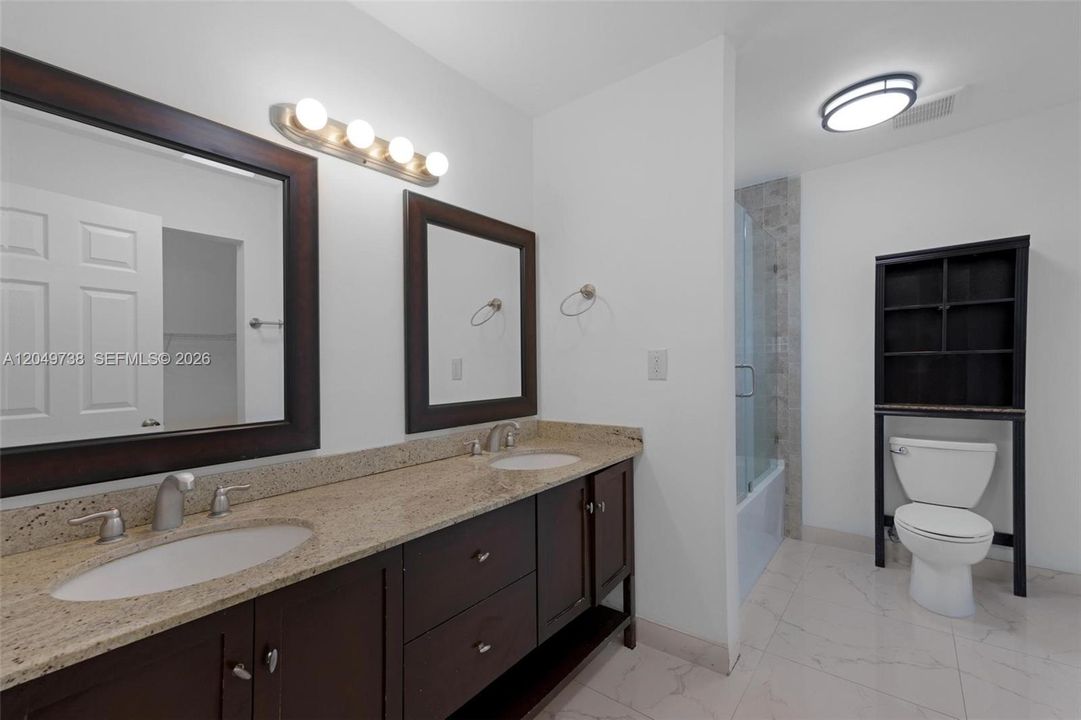 Master bathroom with glass door bath tub/shower