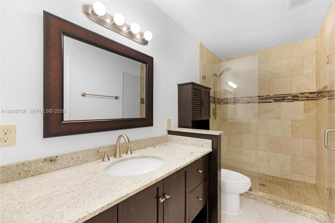 Guest bathroom with glass door shower