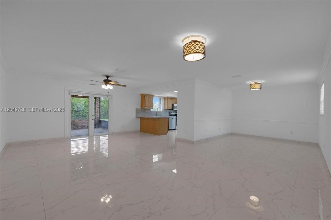 Large living room with French door access to screen-in patio