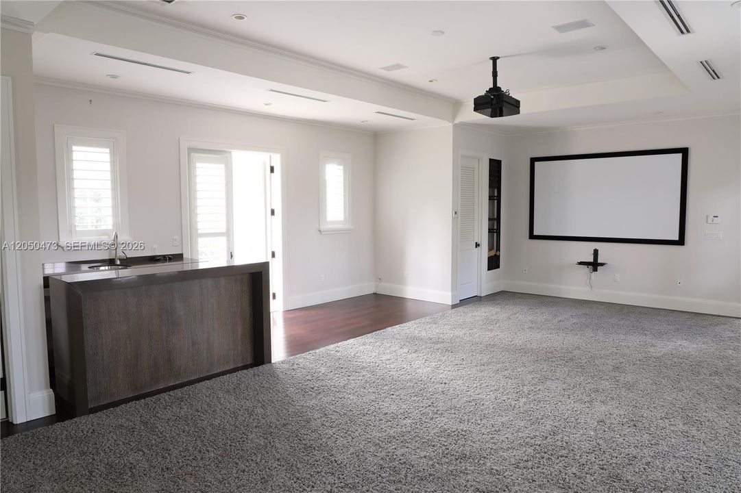 Movie/media/entertainment room with wet Bar, bathroom and 2 balconies facing East and West.