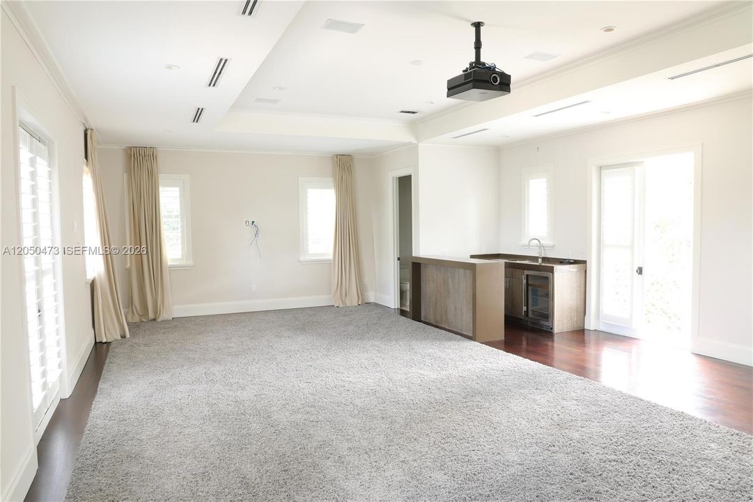 Movie/media/entertainment room with wet Bar, bathroom and 2 balconies facing East and West.