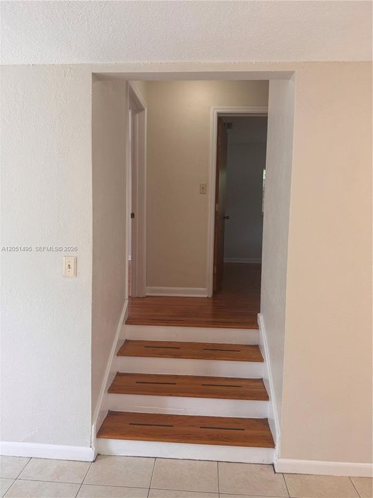 steps going to secondary  bedrooms
