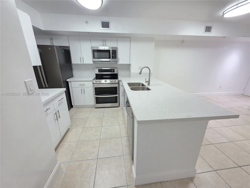 NEW QUARTZ COUNTERTOPS AND CABINETS