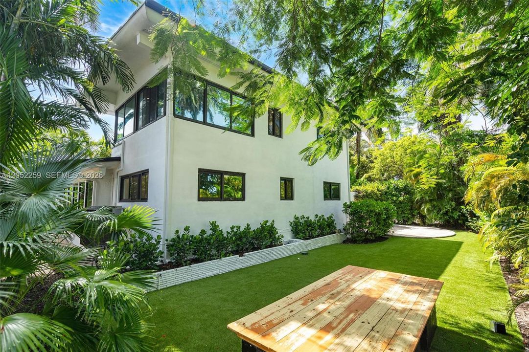 Lush tropical side garden with expansive lawn