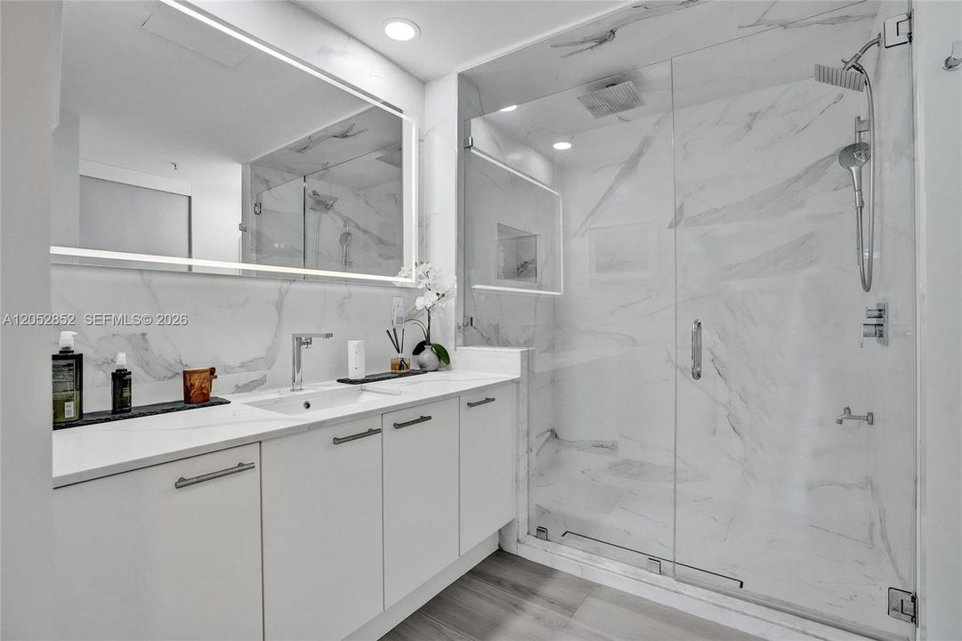 Rainforest showerhead. There are three shower heads in total: one rainforest on the ceiling, one handheld, and one wall-mounted. There is also a hose attachment